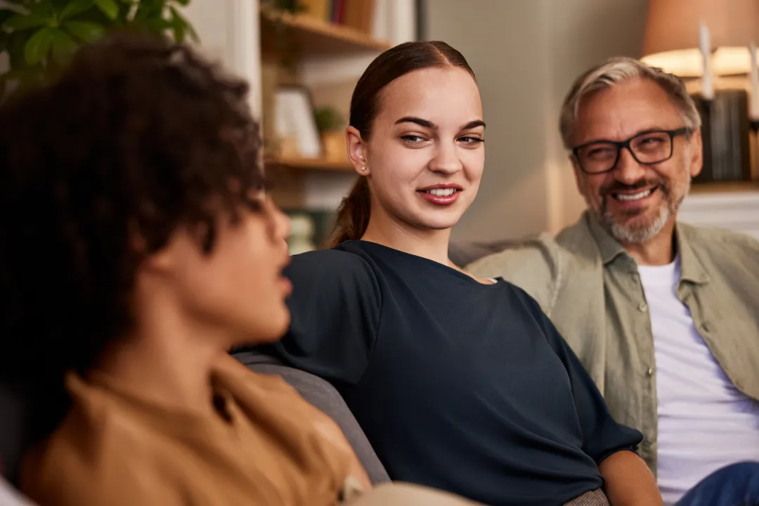 Young people talking with an older man
